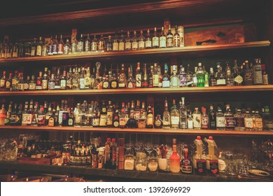 Tainan City, Taiwan - April 19th, 2019: The wine shelves of a bar named "Bar Home", one of good bars in Tainan City, Taiwan. People are talking and drinking wine or drinks in this bar.