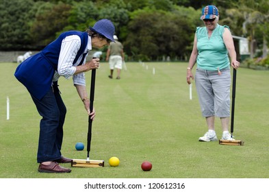 TAIPA - NOV 28 2012:Active Seniors Women Playing Croquet Together. It's The First Outdoor Sport To Embrace Equality, Allowing Both Sexes To Play The Game On An Equal 