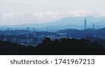 Taipei City skyline and the mountain layering through the evening sky with panoramic view, downtown from the Maokong.