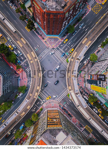 Taipei, Taiwan - 06/26/2019 : Aerial view of\
cars and trains with intersection or junction with traffic, Taipei\
Downtown, Taiwan. Financial district and business area. Smart urban\
city technology.
