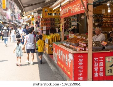 Taipei, Taiwan - 08 April 2019: Old Man Selling Dried Fish And Seafood In His Small Street Food Stall On Tamsui (Danshui) Old Street In The Outskirts Of Taipei.