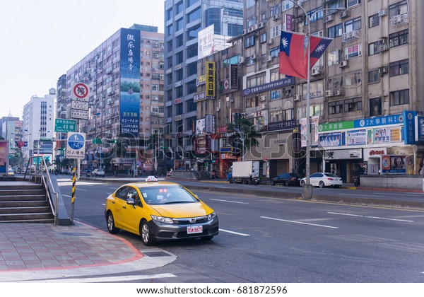 TAIPEI, TAIWAN - 2 January 2017 : Street view\
at Taipei-Keelung main road in Taiwan. There is taxi car waiting\
for the passenger.