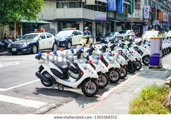 Taipei, TAIWAN - 3 Oct, 2017: Taiwan\
Police cars and motocycle were parking beside the street near\
police station. They ready to use in duty., Taipei, Taiwan\

