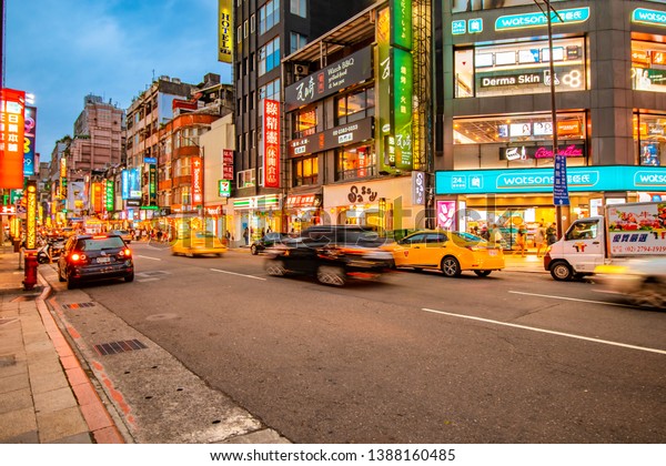 Taipei, Taiwan - April 12, 2019:\
Motion Blur of cars and traffic passing through Chengu Road in\
front of Ximending Shopping district during the evening rush\
hour