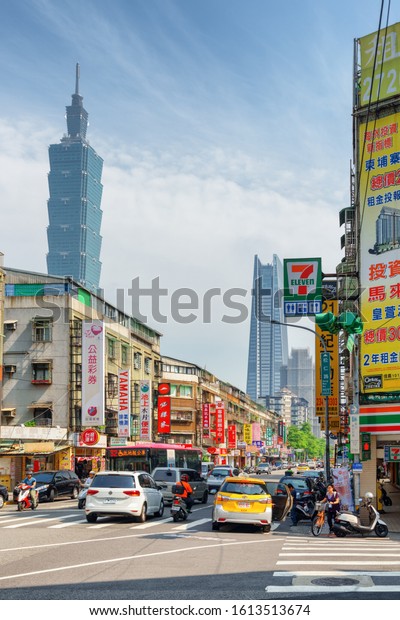 Taipei, Taiwan - April 25, 2019: Fabulous view\
of Songren Road on sunny day. Taipei 101 (Taipei World Financial\
Center) and other skyscrapers are visible on blue sky background.\
Awesome cityscape.