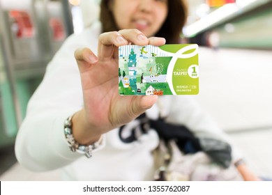 TAIPEI TAIWAN - APRIL 27, 2015: Asian Woman Show Taipei Unlimited Fun Pass For A One Day  In Hand. Gives You Unlimited Rides On MRT, And City Buses, Allowing You To Reach Popular Attractions.
