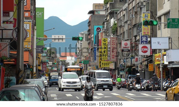 TAIPEI,\
TAIWAN - CIRCA AUGUST 2019 : Scenery of street traffic at Datong\
District. Cityscape of old historical buildings, advertisement\
billboards of shops and stores along the\
road.