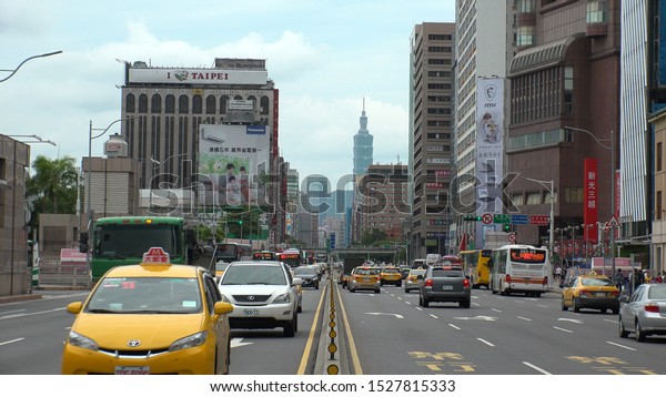 TAIPEI, TAIWAN - CIRCA AUGUST 2019 :\
View of street traffic around Taipei railway station. Many cars,\
motorbikes, taxi and bus on the road in morning rush\
hour.