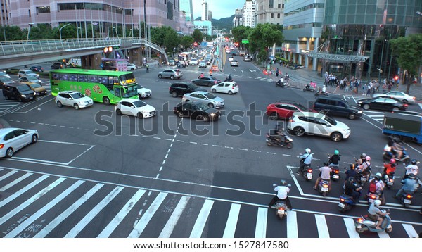 TAIPEI, TAIWAN -\
CIRCA AUGUST 2019 : Scenery of busy street traffic around Xinyi\
district near Taipei 101 building. Many car, bus. taxi and bike at\
the road in evening rush\
hour.