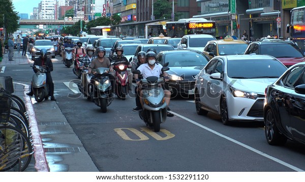 TAIPEI, TAIWAN - CIRCA AUGUST\
2019 : View of many motorbikes and scooters on the road in rush\
hour.