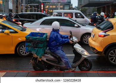 Taipei, Taiwan - December 15 2018: Delivery Man Riding The Motorbike Stuck In The Traffic Jam In The City