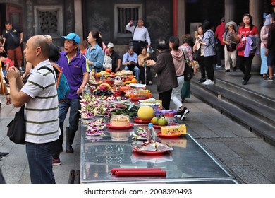 TAIPEI, TAIWAN - DECEMBER 4, 2018: People Leave Food Offerings At A Table Of Longshan Temple In Wanhua District Of Taipei City, Taiwan. It Is A Chinese Folk Religion Landmark.