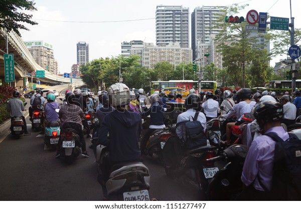 TAIPEI, TAIWAN - JUNE 25,\
2018: Motorway with busy Motorcycles during rush hour in Taipei\
city, Taiwan.