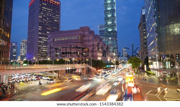 Taipei/Taiwan - 08.07.2019\
View of the Asian city\
at night. Skyscraper on the background of colored lights of cars,\
taxis, buses. The highway lights of the capital of Taiwan. Road\
traffic in the\
city.