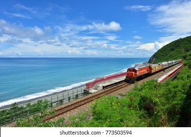 Taitung City, Taiwan, the train traveling along the coastline, a clear blue sky and white clouds and the ocean is a beautiful picture.