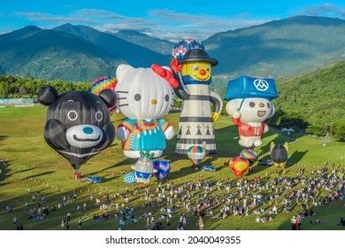 Taitung, Taiwan - August 29, 2021: Various Shape Balloons With Beautiful Sunrise And Green Grass At Luye Highland, Taiwan International Balloon Festival