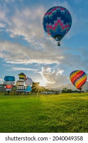 Taitung, Taiwan - August 29, 2021: Various Shape Balloons With Beautiful Sunrise And Green Grass At Luye Highland, Taiwan International Balloon Festival