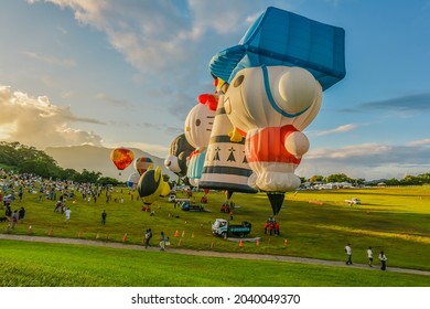 Taitung, Taiwan - August 29, 2021: Various Shape Balloons With Beautiful Sunrise And Green Grass At Luye Highland, Taiwan International Balloon Festival