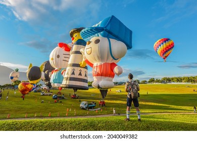 Taitung, Taiwan - August 29, 2021: Various Shape Balloons With Beautiful Sunrise And Green Grass At Luye Highland, Taiwan International Balloon Festival