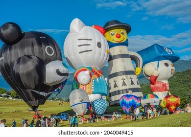 Taitung, Taiwan - August 29, 2021: Various Shape Balloons With Beautiful Sunrise And Green Grass At Luye Highland, Taiwan International Balloon Festival