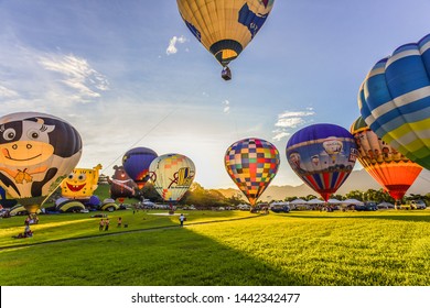 Taitung, Taiwan - June 30, 2019: Various Shape Balloons With Beautiful Sunrise And Green Grass At Luye Highland, Taiwan International Balloon Festival