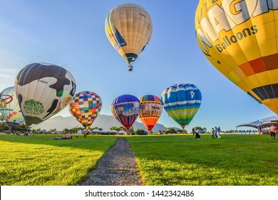 Taitung, Taiwan - June 30, 2019: Various Shape Balloons With Beautiful Sunrise And Green Grass At Luye Highland, Taiwan International Balloon Festival