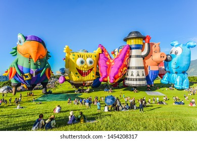 Taitung, Taiwan - June 30, 2019: Various Shape Balloons With Beautiful Sunrise And Green Grass At Luye Highland, Taiwan International Balloon Festival