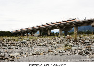 Taitung, Taiwan-3／23／2021: A Taroko Express Train Passes Through The Dry Lijia River From The Bridge.