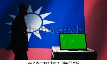 Taiwan army commander devising strategy to combat Chinese propaganda next to green screen tablet. Taiwanese freedom fighter walking in operation room in front of mockup device, camera B