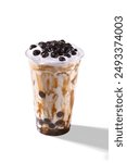 Taiwan brown sugar fresh milk bubble tea glass on white background. Cheese Cream fresh milkfoam with Black pearl tapioca bubble tea with brown sugar syrup glass, tea leaves and floating bubbles tea
