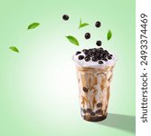 Taiwan brown sugar fresh milk bubble tea glass on pastel background. Cheese Cream milkfoam with Black pearl tapioca bubble tea glass, tea leaves and floating bubbles tea, copy space poster ad.
