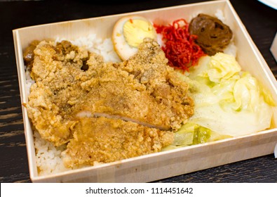 Taiwanese Lunch Box Served In Bamboo Lunch Box With Fried Pork Chop, Vegetables And Egg On Rice. It Is Known As Railroad Bento In Taiwan