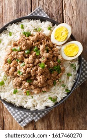 Taiwanese Pork Minced Meat With Rice And Eggs Close-up In A Bowl On The Table. Vertical Top View From Above
