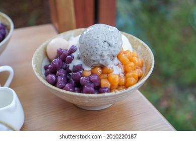 Taiwanese Shaved Ice With Toppings. A Bowl Of Milk Shaved Ice Topped With Taro Balls, Rice Ball And Black Seseme Ice Cream. (isolated)