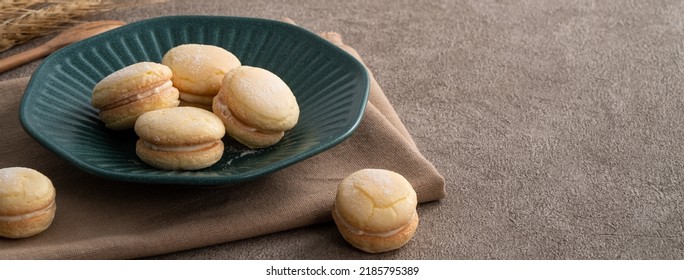 Taiwanese style traditional macaron dessert in a plate for afternoon tea on gray table background.
