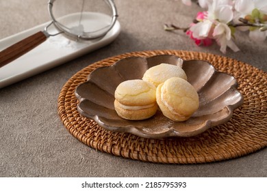 Taiwanese style traditional macaron dessert in a plate for afternoon tea on gray table background.