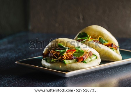 Similar – Image, Stock Photo Bread buns in a basket hanging on a blue wall