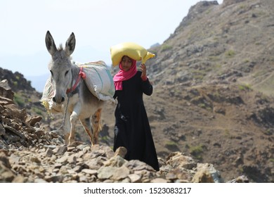 Taiz  Yemen -02 Apr 2017: Yemeni Women Bring Their Food And Drink Needs Through Rugged Mountain Roads Because Of  Al-Houthi Militia Siege Of The Villages Of Jabal Habashi District In The In Taiz City