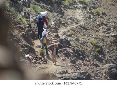 Taiz / Yemen - 02 Apr 2017: Children And Women Their Food And Drink Needs Through Rugged Mountain Roads Because Of Al-Houthi Militia Siege Of The Villages Of Jabal Habashi District In The West Of Taiz