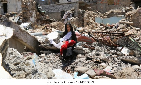 Taiz  Yemen - 13 Apr 2017 : A Sad Yemeni Girl Due To The Great Destruction Left By The Violent Battles Between The National Army And The Houthi Militia In Taiz City , Yemen