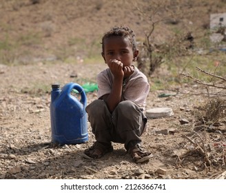 Taiz Yemen - 18 Feb 2022 : A sad child searches for water in the camps for the displaced from the war in the city of Taiz, Yemen