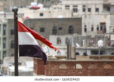 Taiz  Yemen - 22 Aug 2016 : Yemeni Flag In Front Of Buildings Destroyed By The War On The City Of Taiz 
 