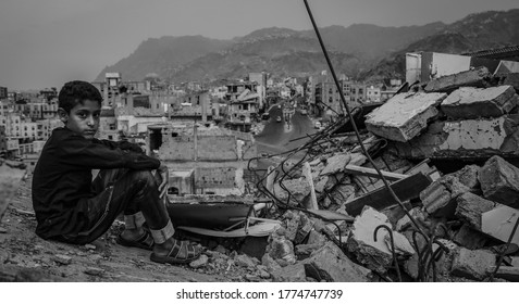 Taiz  Yemen - 22 Aug 2016 : A camouflage of a sad Yemeni child sits on the rubble of a destroyed house in the city of Taiz, Yemen.