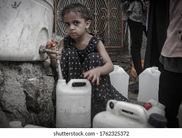 Taiz  Yemen - 23 June 2020 : Children fetch water due to the water crisis and the difficult living conditions witnessed by residents of the Taiz city in southern Yemen since the beginning of the war