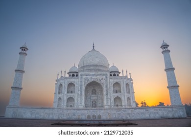 Taj Mahal landscape in the fog at sunrise. Eighth Wonder of the world Taj Mahal from Agra clicked during sunrise with a beautiful golden sky in the background.