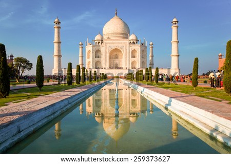 Taj Mahal on a bright and clear day at sunset, reflects in the pond.