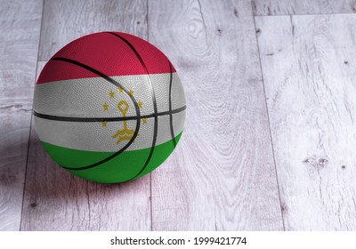 Tajikistan Flag Is Featured On A Basketball. Basketball Championship Concept.