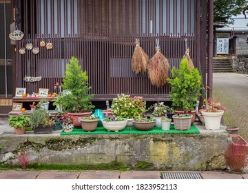 Takayama/Japan - November 18, 2019: A  Small Container Garden Near A Wooden House.