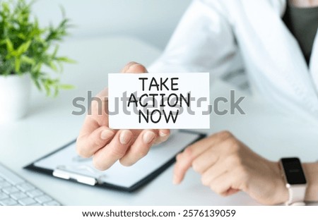 Take Action Now is an imperative statement urging someone to act promptly or immediately, text concept on card. High quality photo