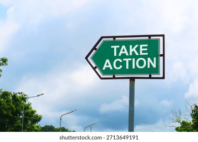 Take Action Road Sign with Dramatic Clouds and Sky.